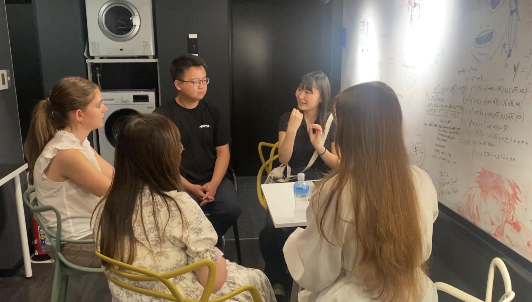 Residents around a table at a Japan Club language exchange session